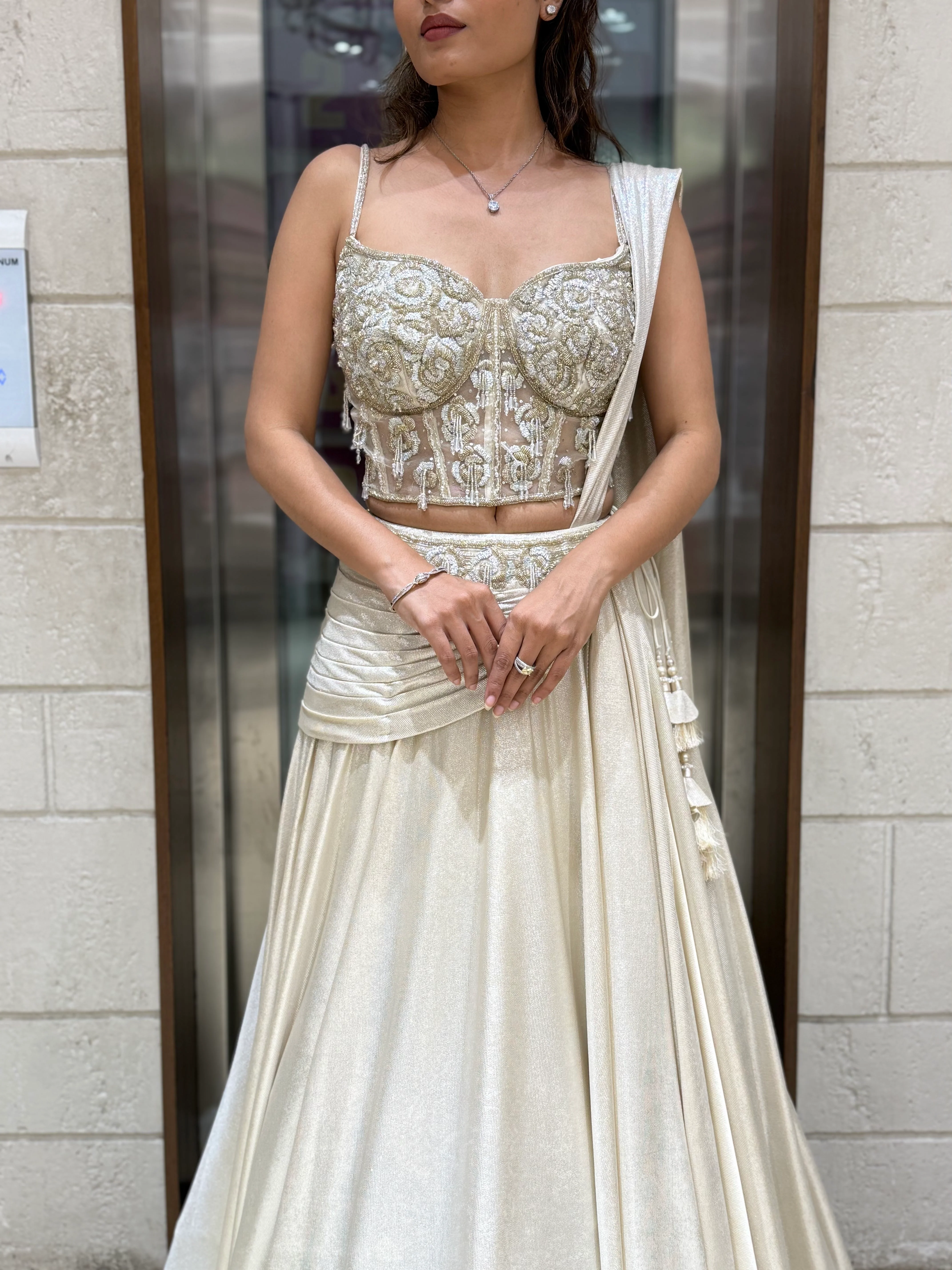 Ivory Shimmer Draped Lehenga Set with Hand-Embroidered Corset Blouse - Image 2