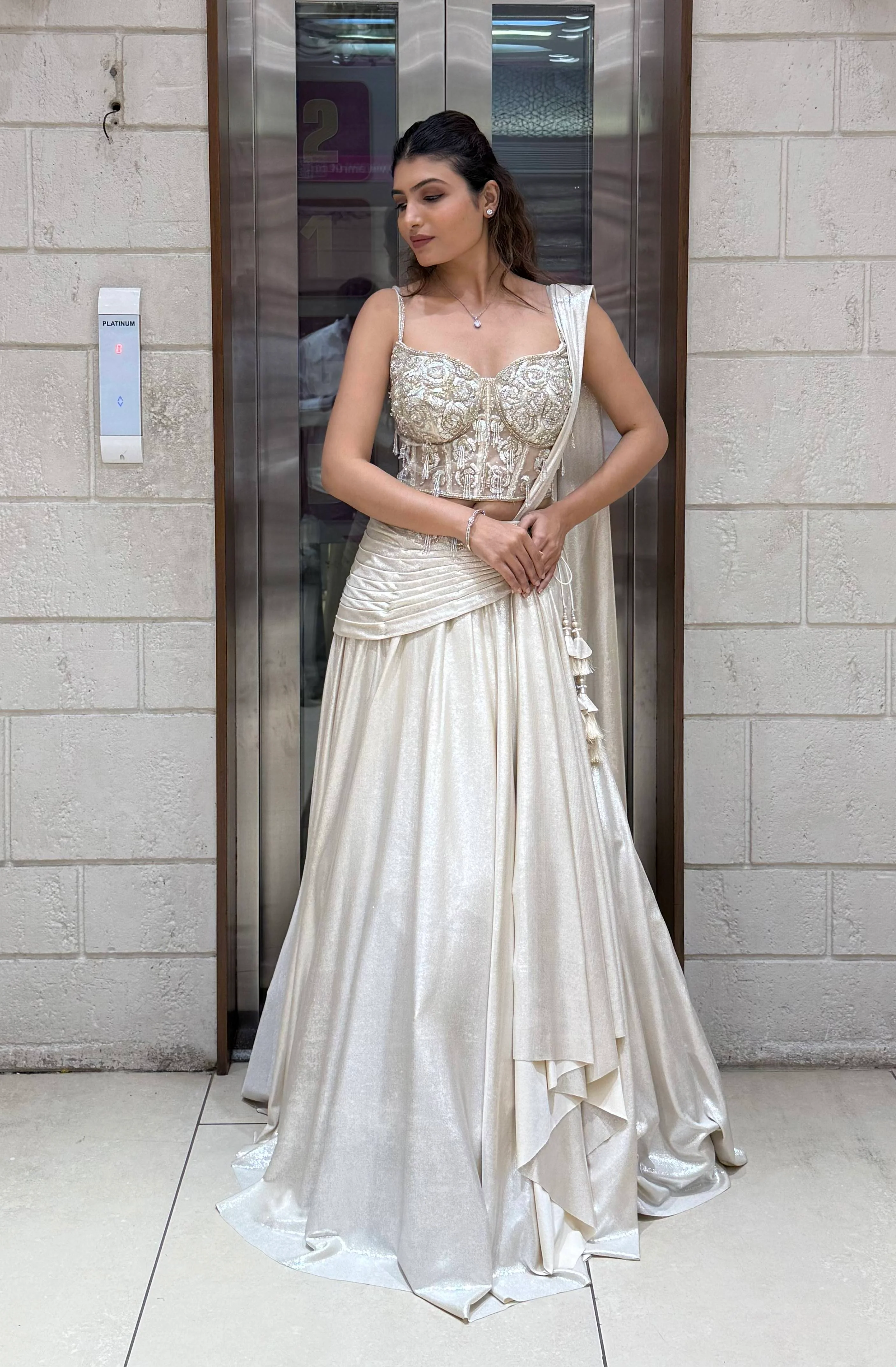 Ivory Shimmer Draped Lehenga Set with Hand-Embroidered Corset Blouse - Image 3