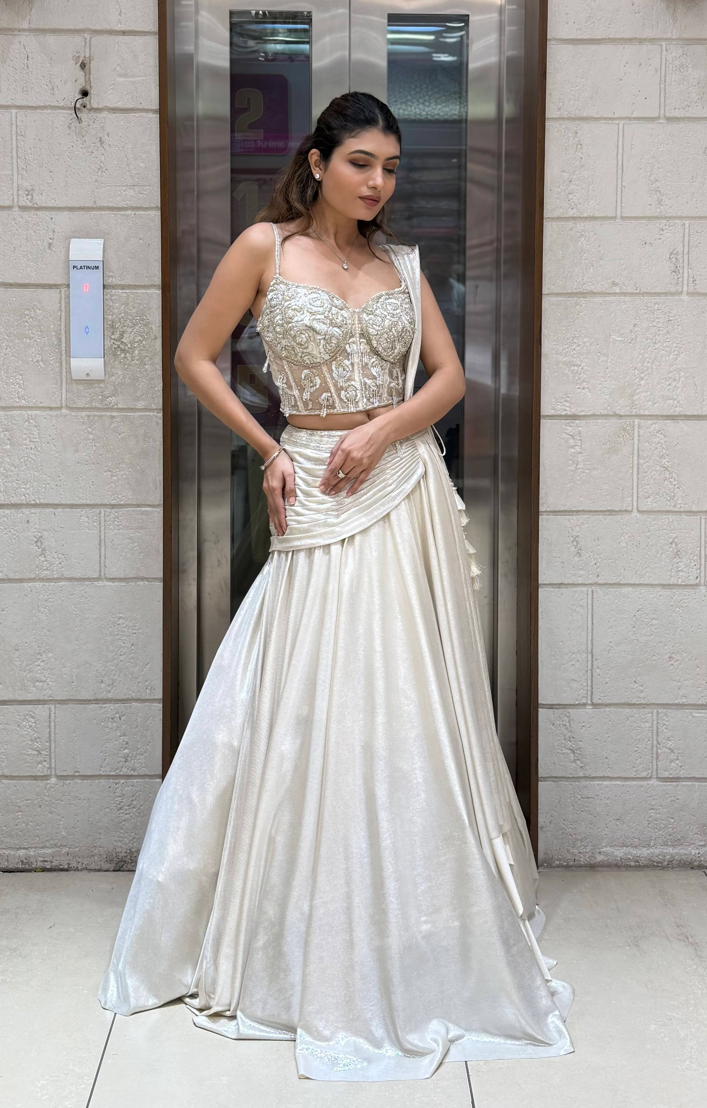 Ivory Shimmer Draped Lehenga Set with Hand-Embroidered Corset Blouse - Image 4