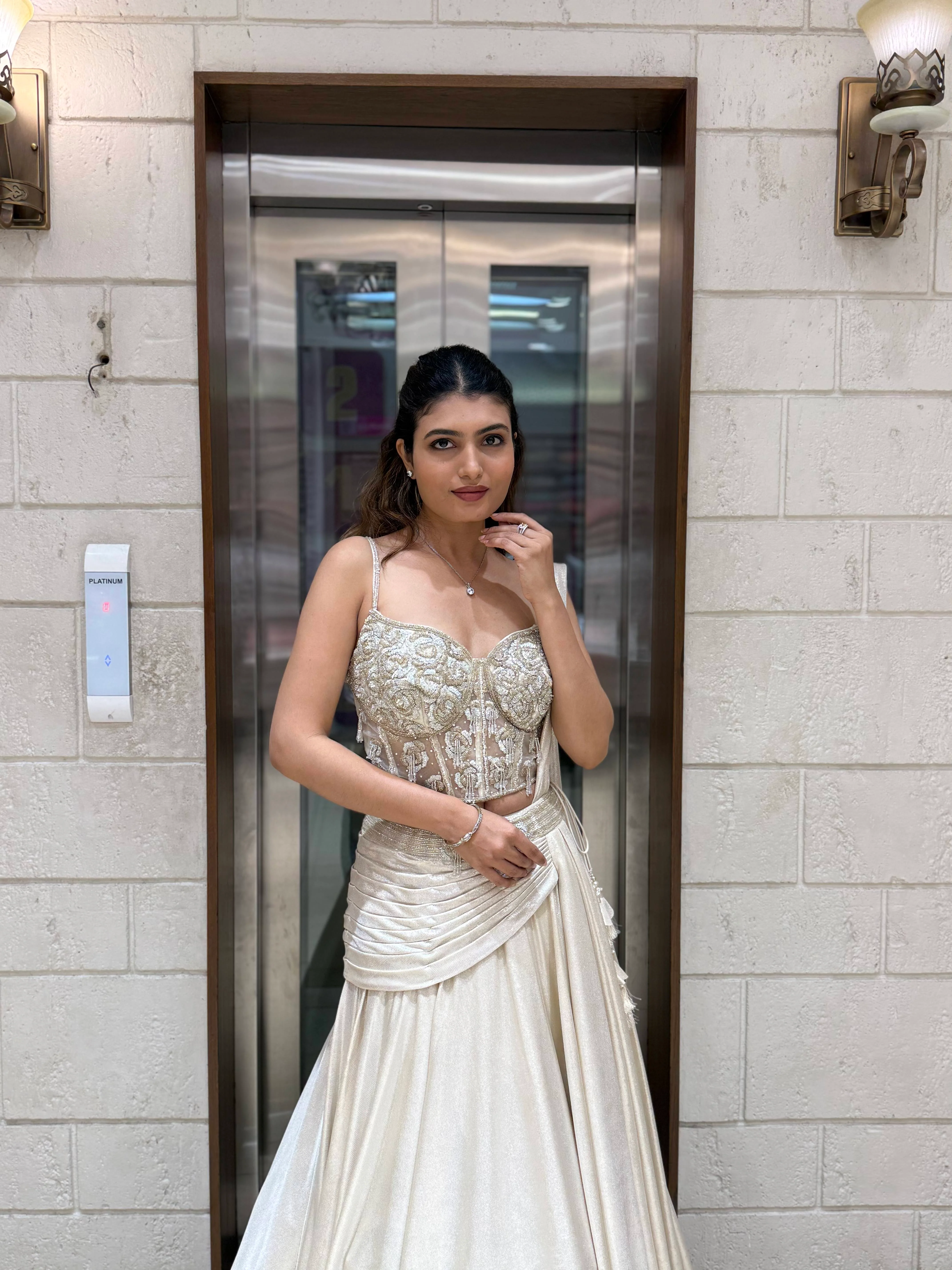 Ivory Shimmer Draped Lehenga Set with Hand-Embroidered Corset Blouse - Image 5