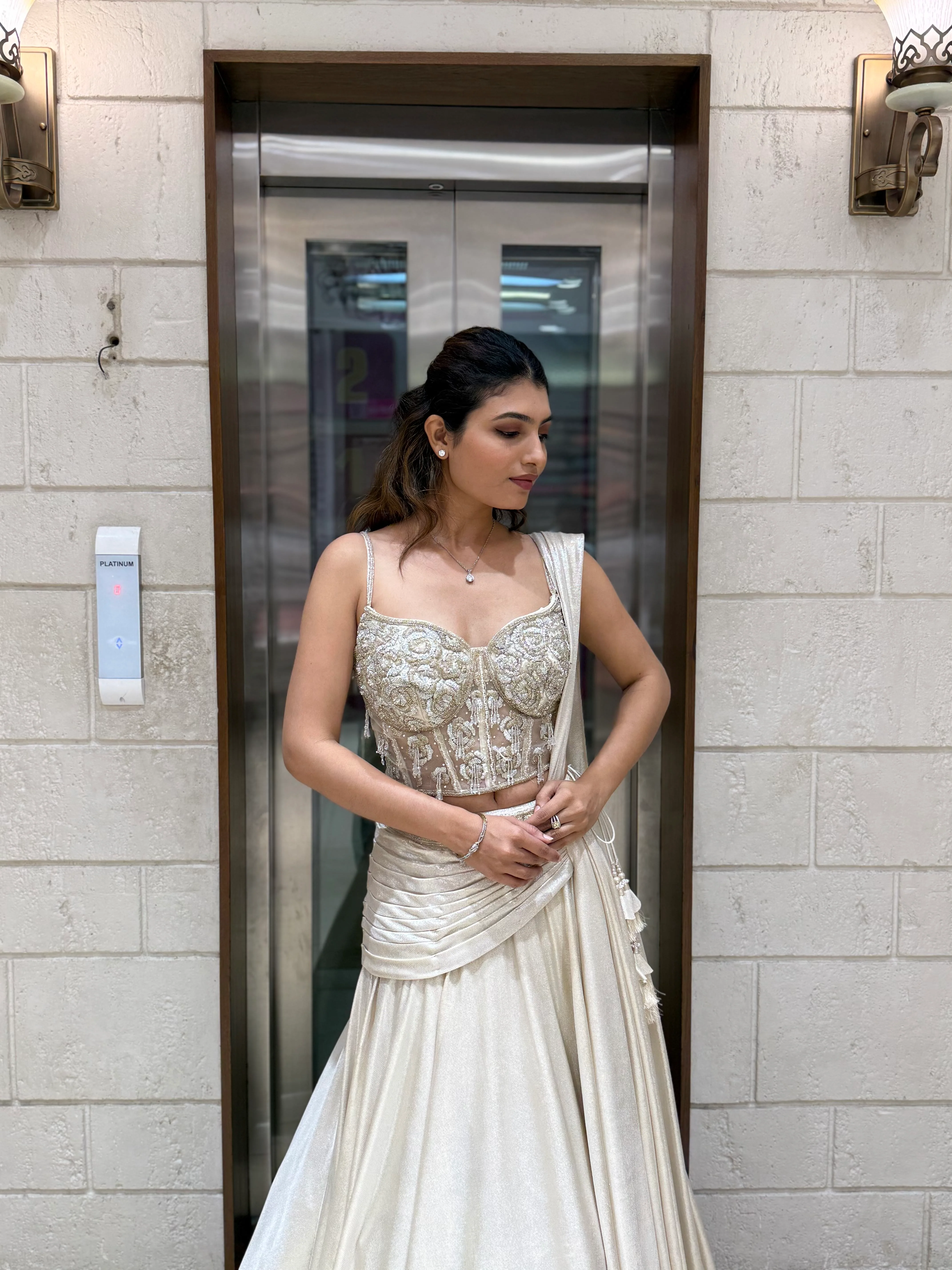 Ivory Shimmer Draped Lehenga Set with Hand-Embroidered Corset Blouse - Image 6