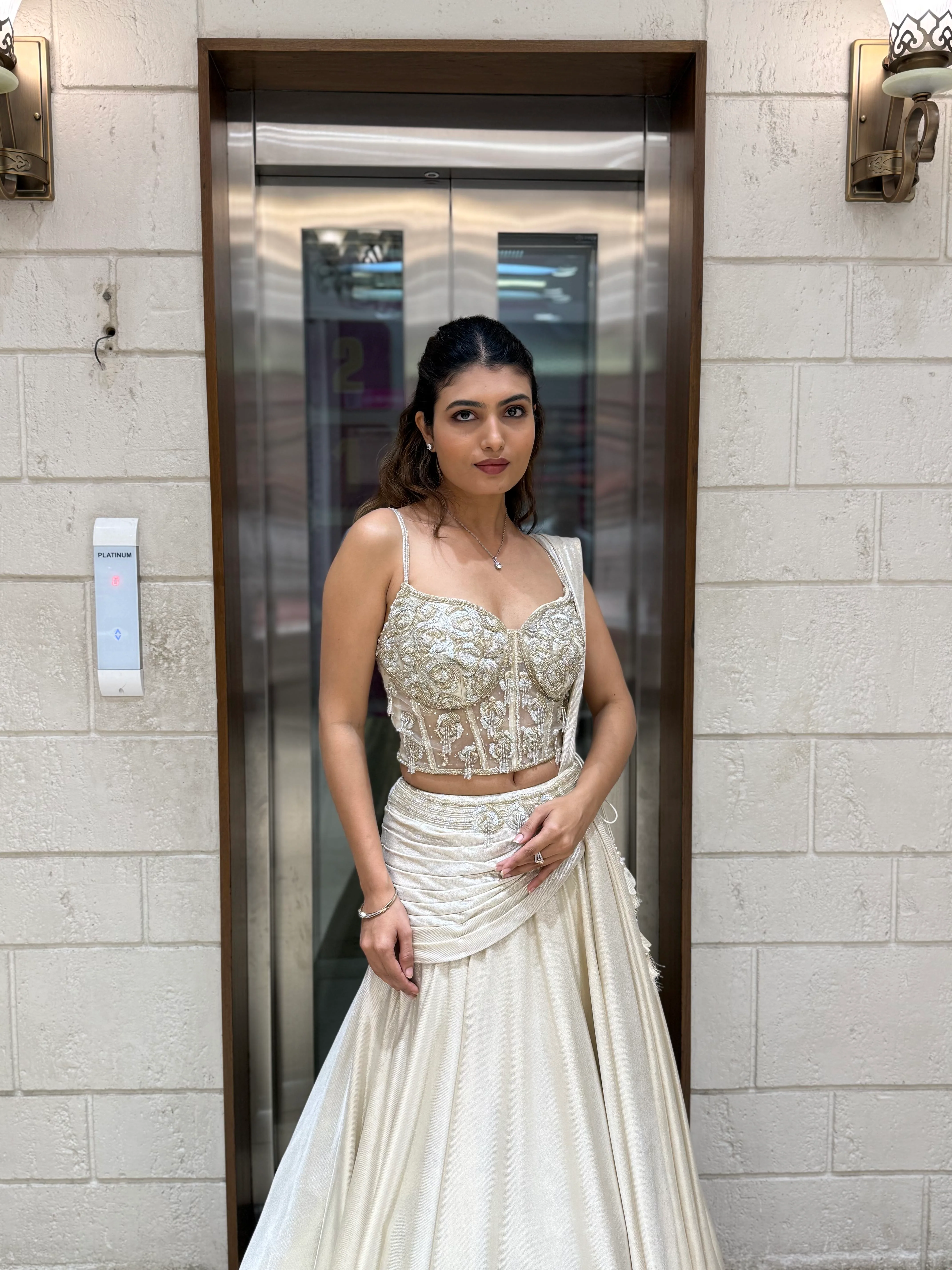 Ivory Shimmer Draped Lehenga Set with Hand-Embroidered Corset Blouse - Image 7