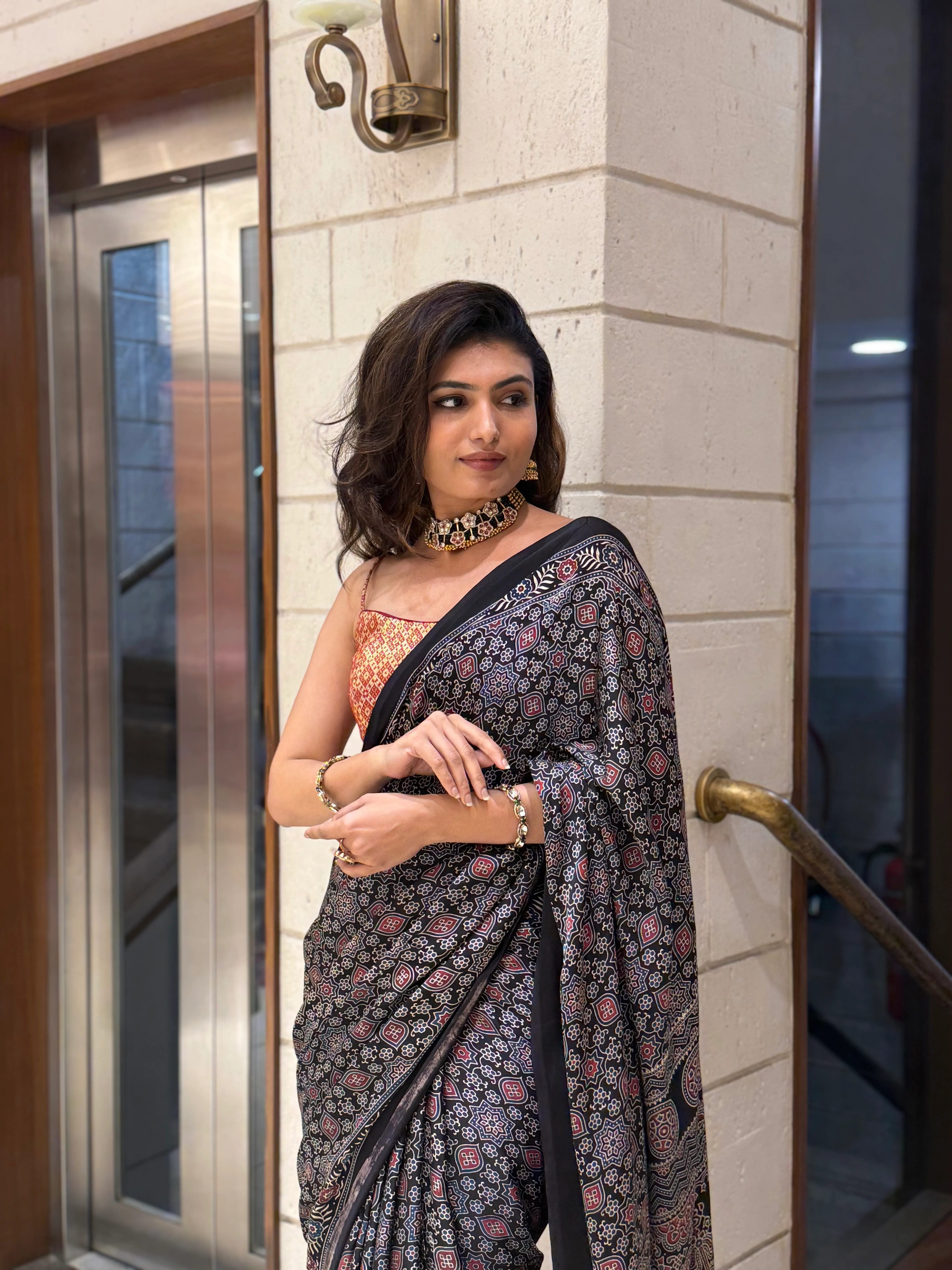 Luxury Black Ajrakh Printed Satin Silk Saree with Copper Blouse & Handcrafted Tassel Pallu - Image 2